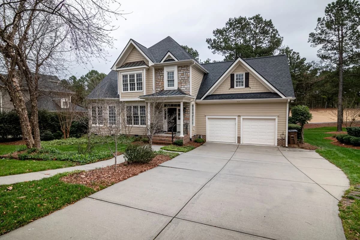 A family home with a landscaped front garden; illustrative stock photography, not a Broom Home listing.